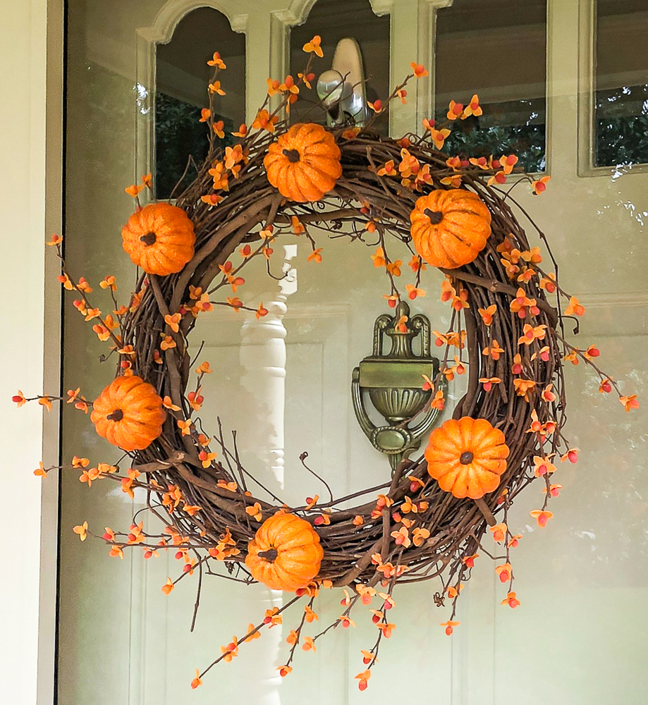 Fall wreath decorated with pumpkins and bittersweet