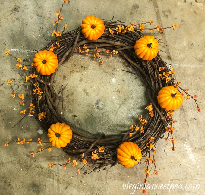 Grapevine wreath with six pumpkins and bittersweet