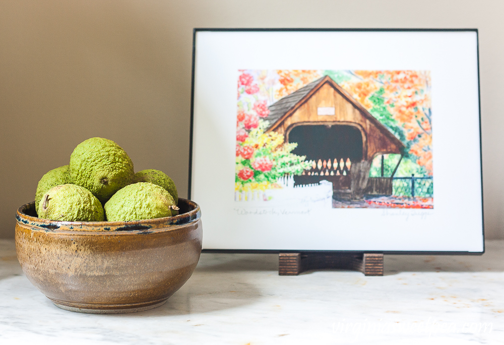 Watercolor of a covered bridge in Woodstock, Vermont with a Walnuts in a North Carolina pottery bowl filled with walnuts