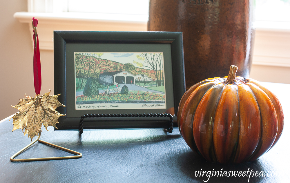 Postcard showing Pulp Mill Covered Bridge in Middlebury, Vermont with a gold covered Vermont Maple leaf and a hanger, and a ceramic pumpkin