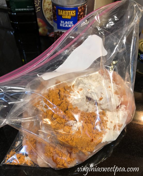 Chicken in a plastic bag with flour and fajita seasoning