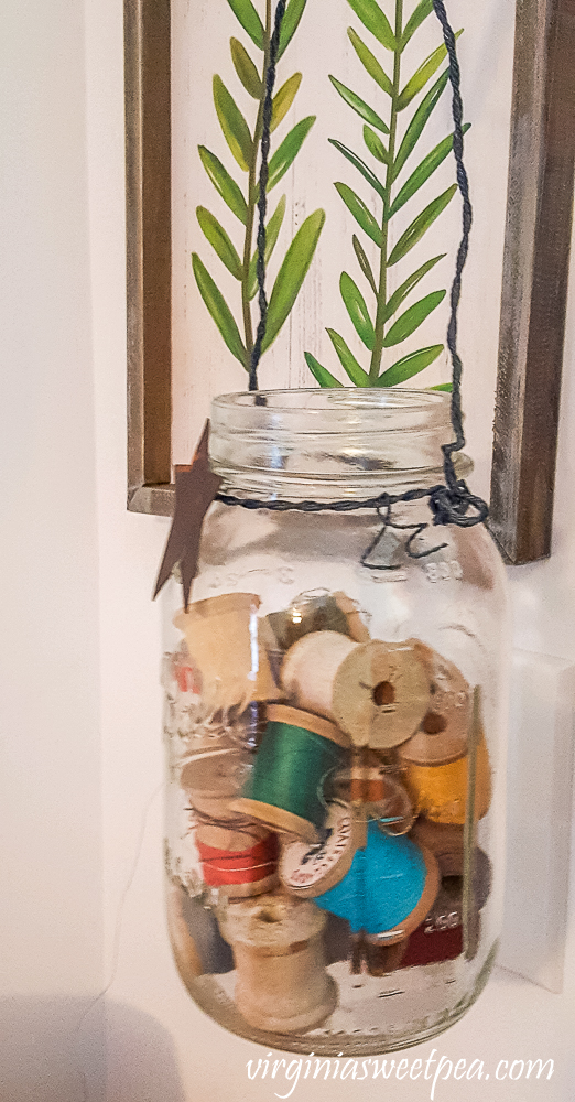 Vintage spools of thread in a Mason jar.