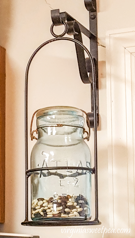 Atlas E-Z jar with beans hanging beside a door.