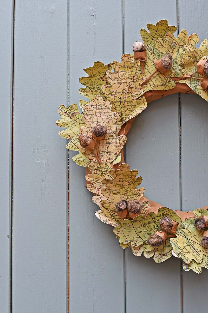 Fall wreath decorated with leaves made from maps