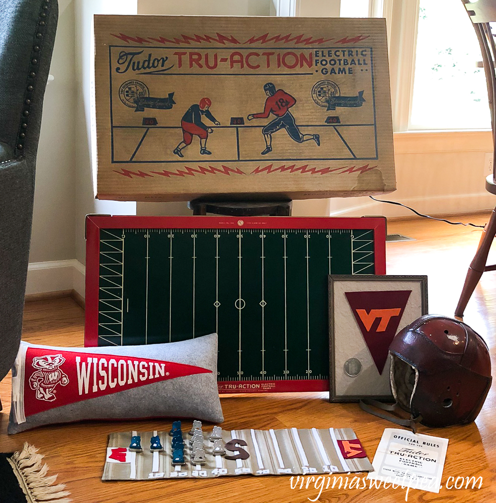 Vintage football display with Tudor Tru-Action Electric football game, 1920s football helmet, Wisconsin pennant pillow