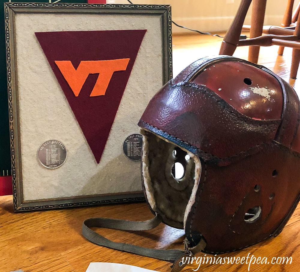 1920s football helmet, VT felt pennant with two coins showing 1973 and 1974 Virginia Tech football schedule