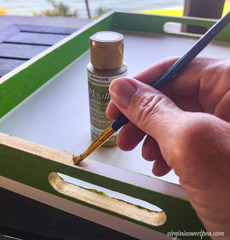 Trimming a painted white wooden tray in gold accent paint