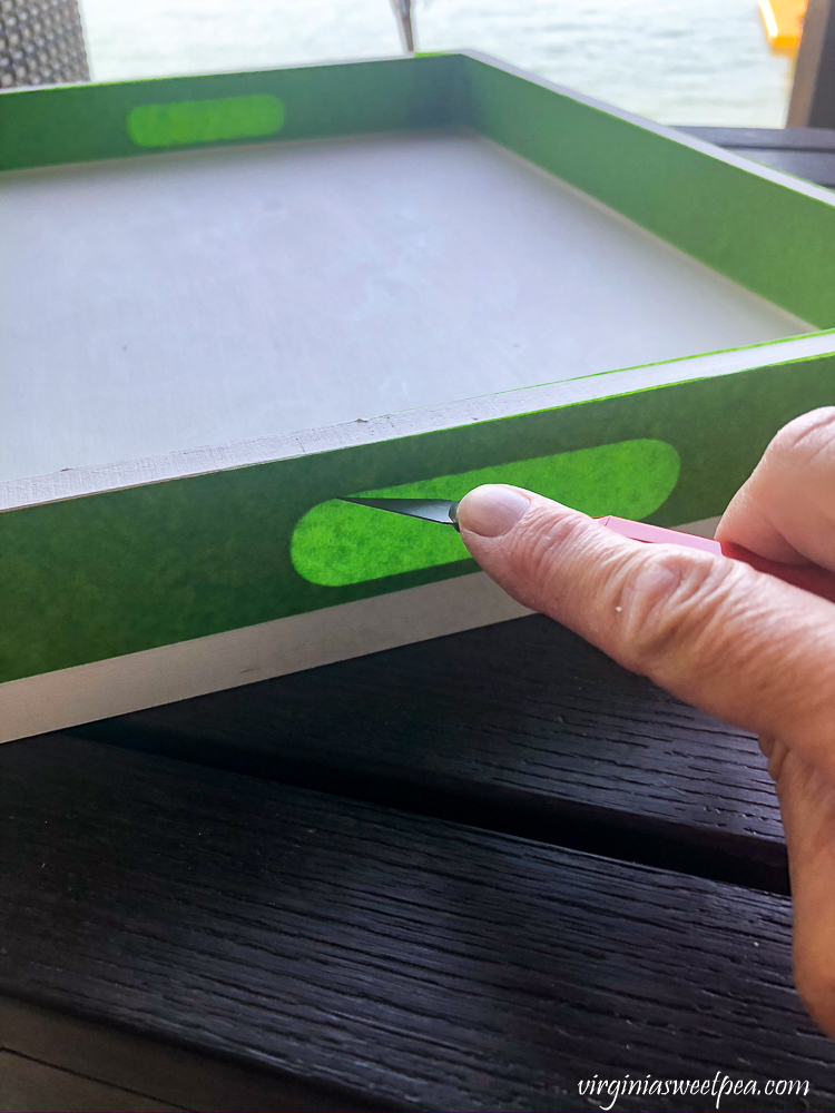Using an exacto knife to cut Frog Tape