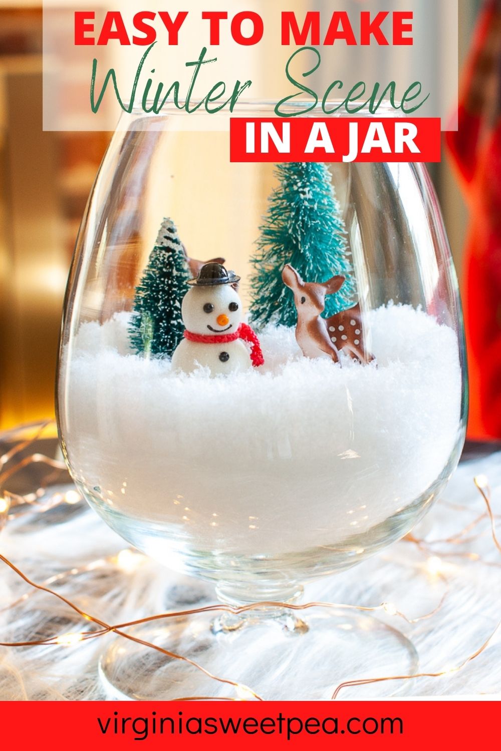 Snow filled brandy sniffer with a Christmas scene including miniature trees, snowman, and deer