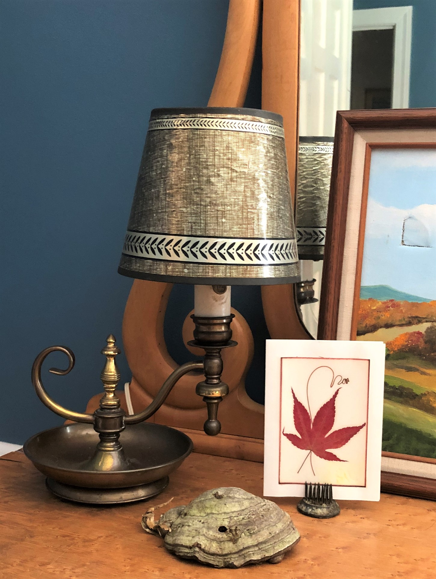 Vintage brass lamp with pressed maple leaf and dried shelf fungus