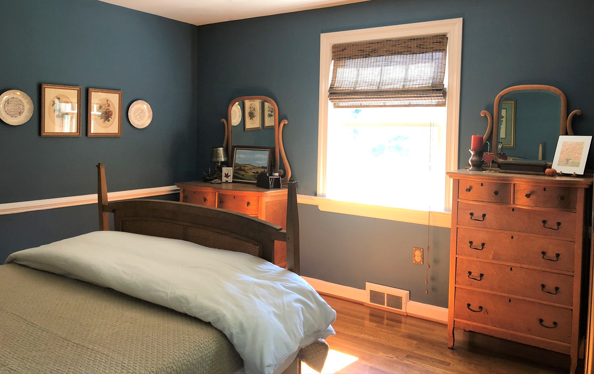 Master bedroom with blue walls and antique Bird's Eye Maple furniture