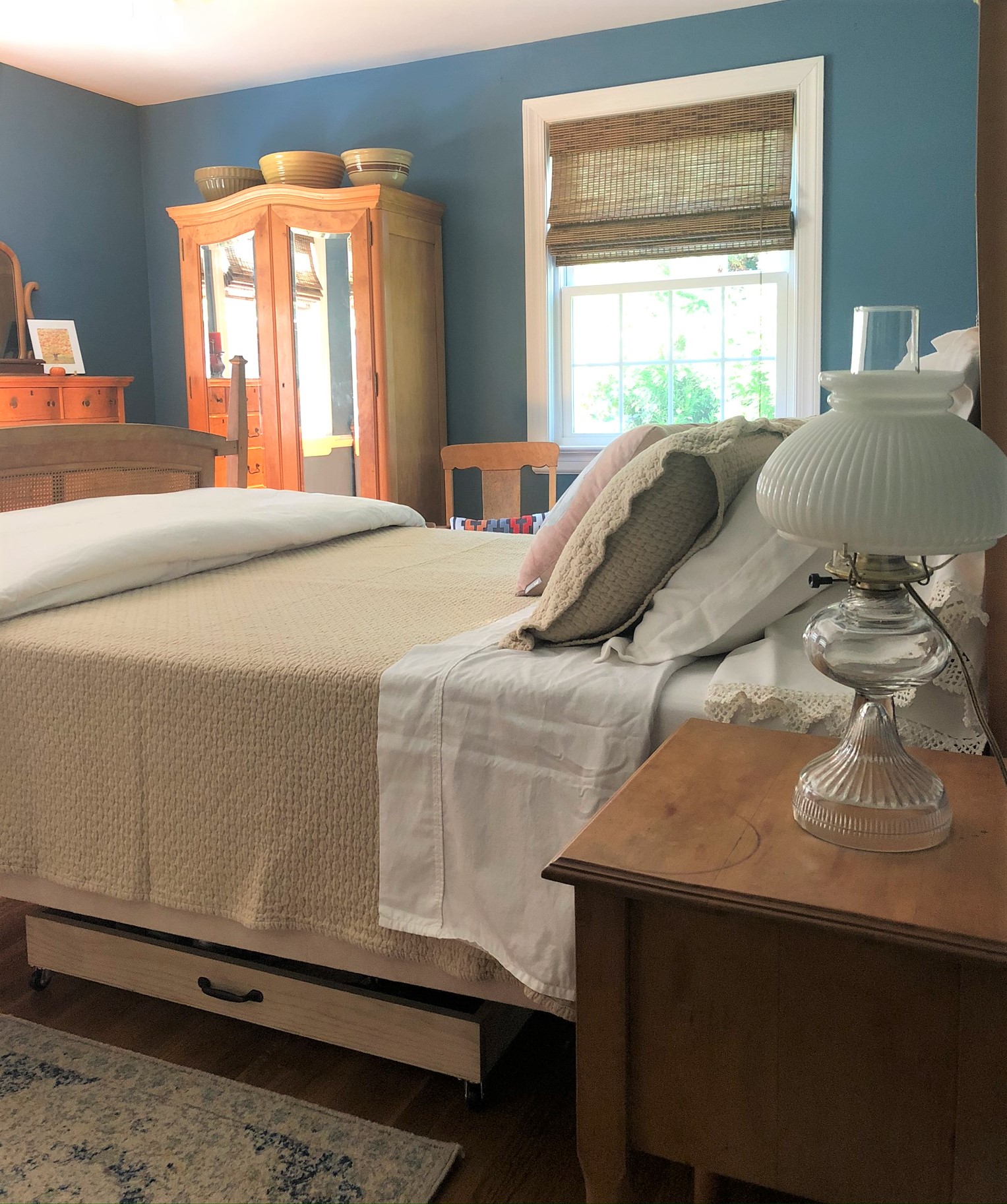 Master bedroom with blue walls and antique Bird's Eye Maple furniture