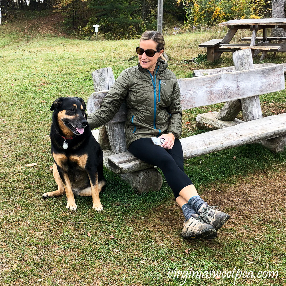 Woman petting dog at the summit of Mt. Peg in Woodstock, Vermont