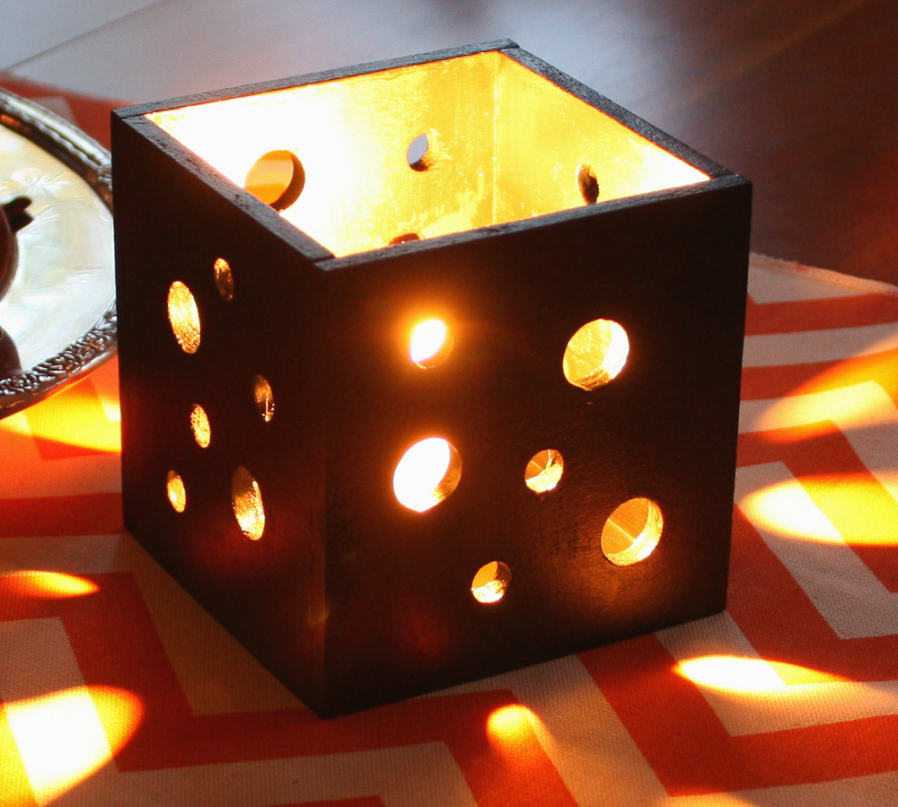Box shaped Candle holder with holes in the sides