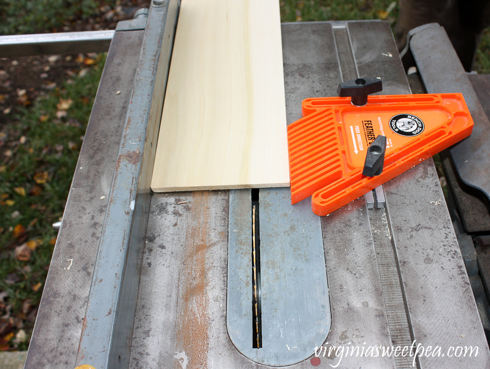 Using a table saw to cut a piece of wood to size