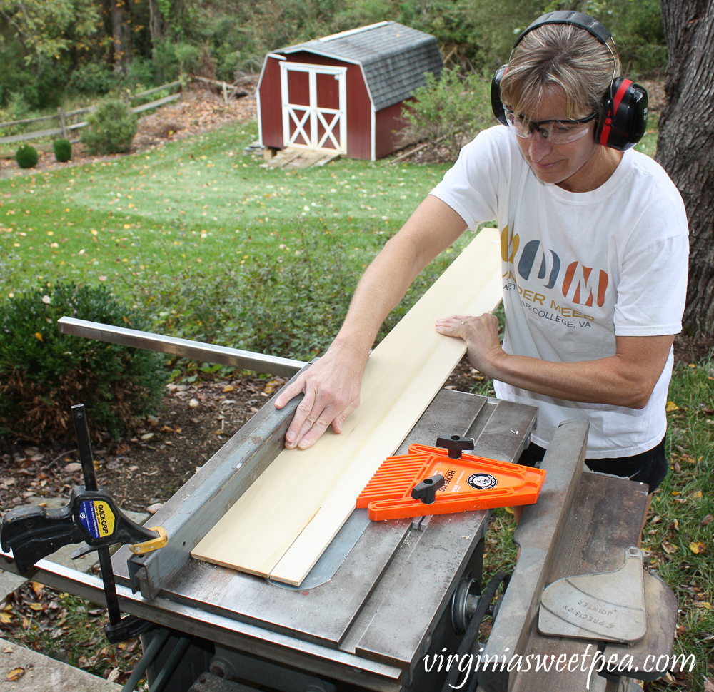 Using a table saw to cut a piece of wood at an angle