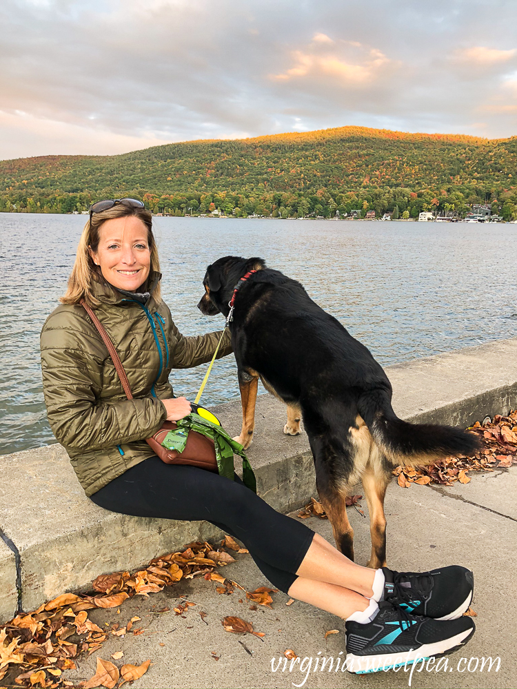 Woman and dog enjoying Lake George, NY on a fall evening.