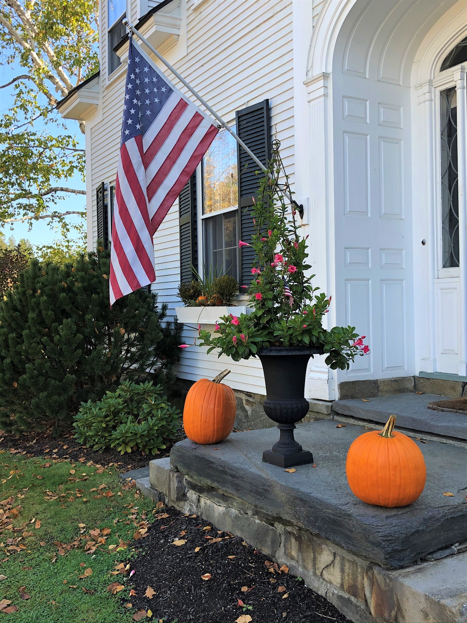 Porch decorated with orange pumpkins