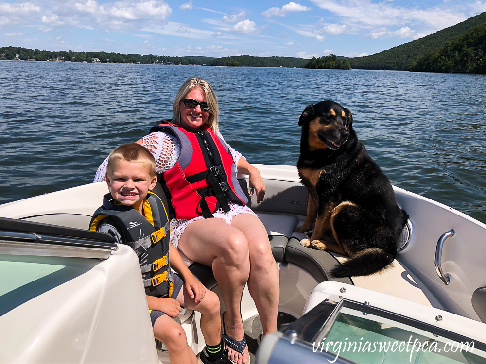 Mom, child, and dog on a boat at Smith Mountain Lake, VA