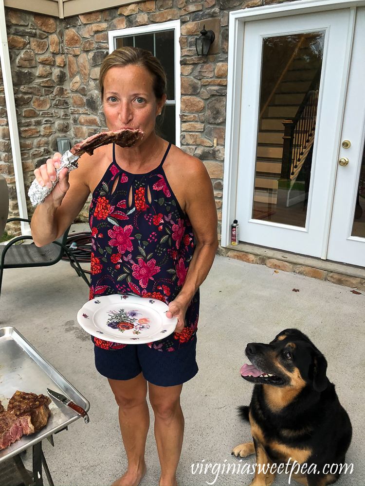 Enjoying a tomahawk steak bone with a dog