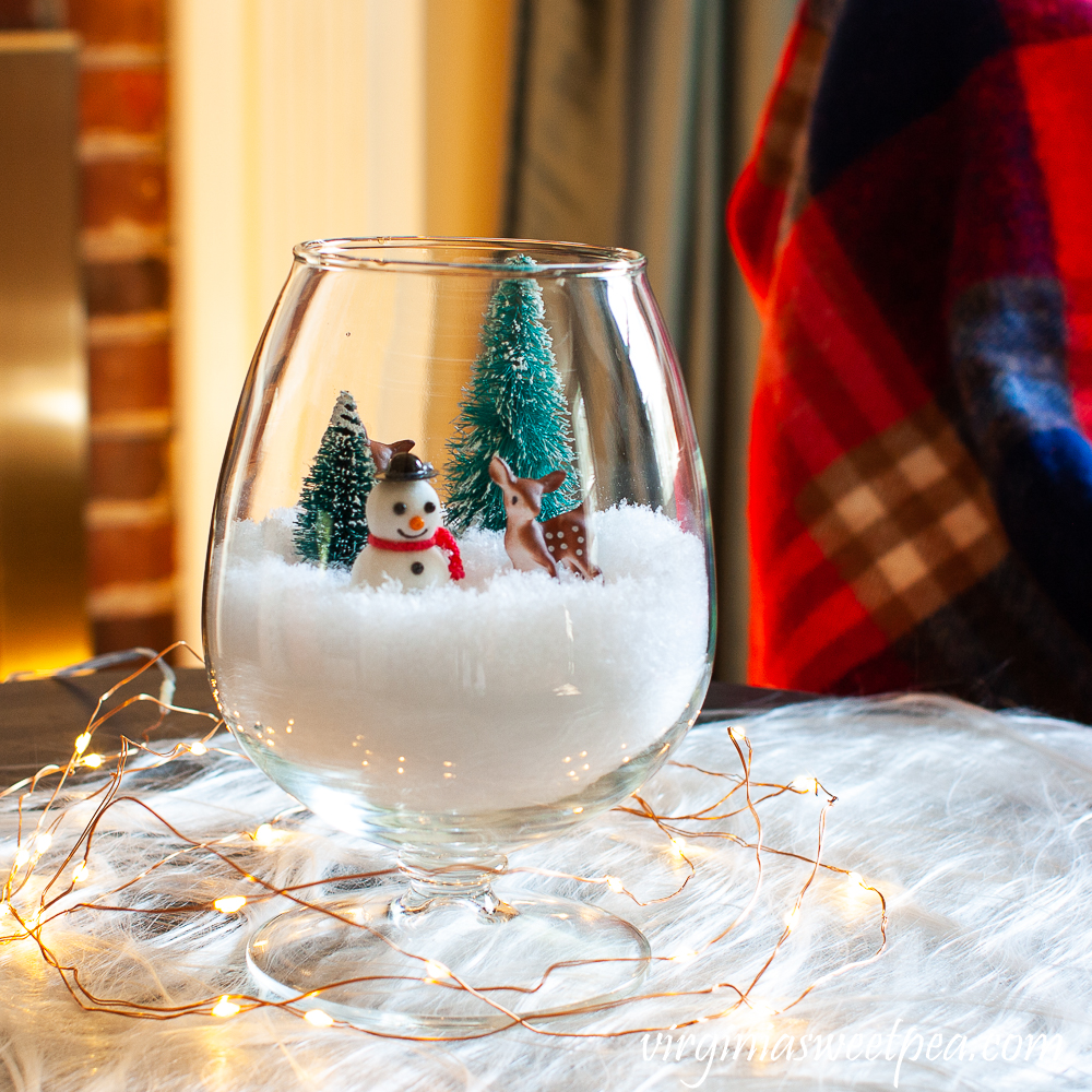 Snow filled brandy sniffer with a winter scene