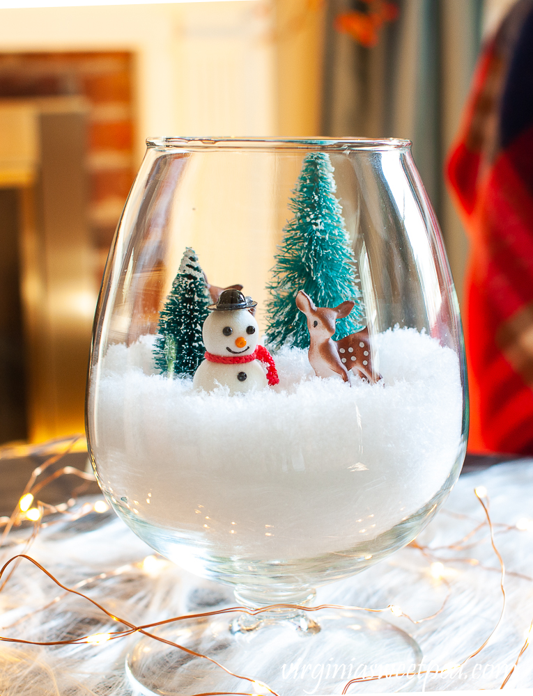 Winter scene in a jar make with a snow filled brandy sniffer with a Christmas scene