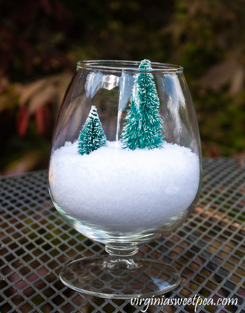 Brandy sniffer with snow and two miniature trees