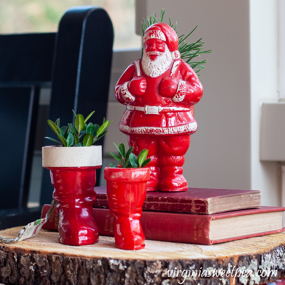 Two vintage Santa boots with Boxwood and a vintage Santa candy holder