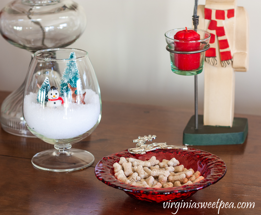 Dog treats in a reindeer bowl with snowman Christmas decor