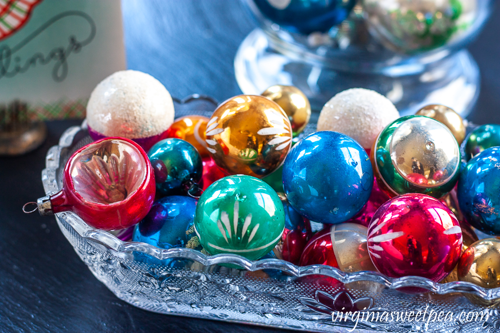 Vintage Christmas balls in an antique glass celery dish