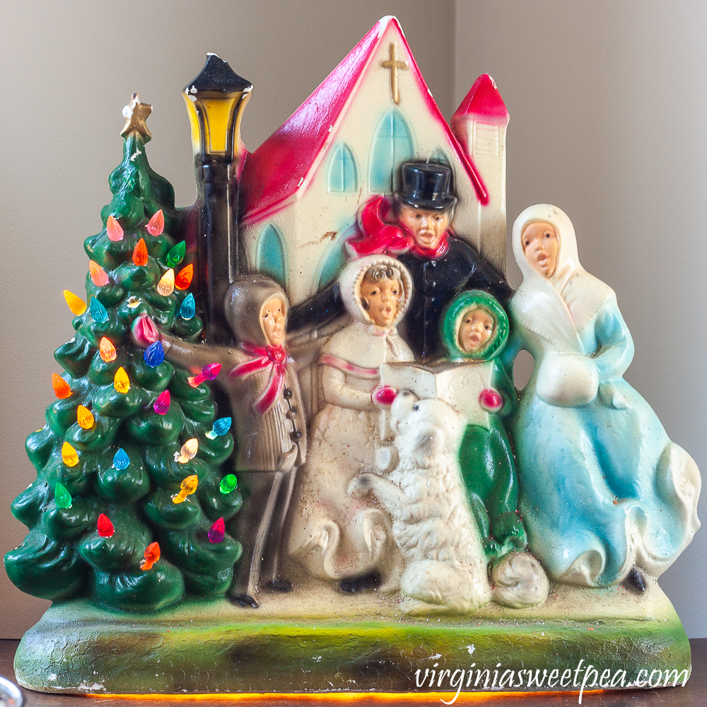 Vintage ceramic carolers with church with tree that lights up.