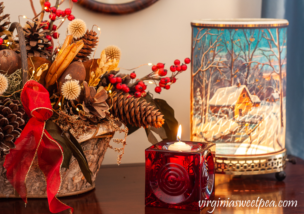 Vintage Econolite motion lamp, red Blenko glass candle holder, and birch bark basket with dried natural elements