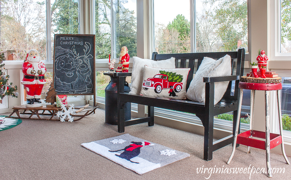 Porch decorated for Christmas with vintage Santas