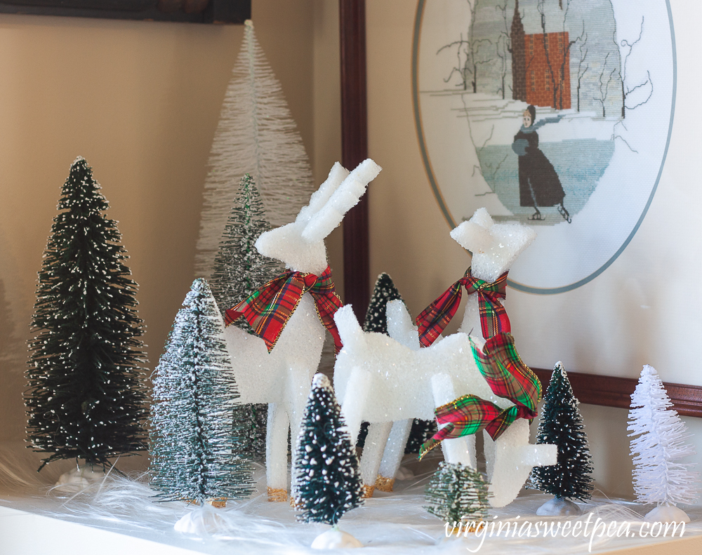 Three styrofoam reindeer with bottle brush trees