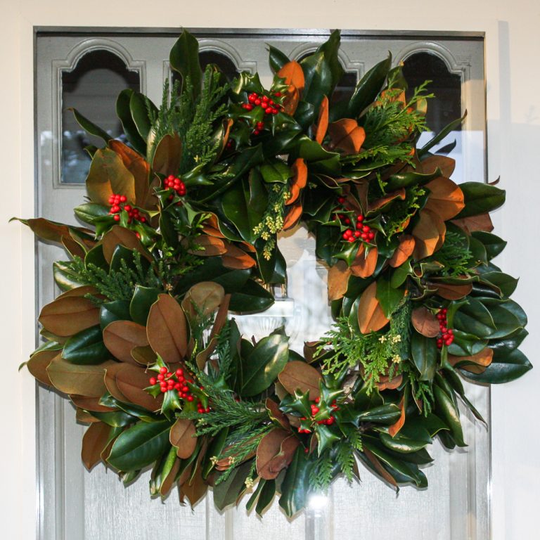 Handmade Magnolia wreath with two evergreen varieties and holly added