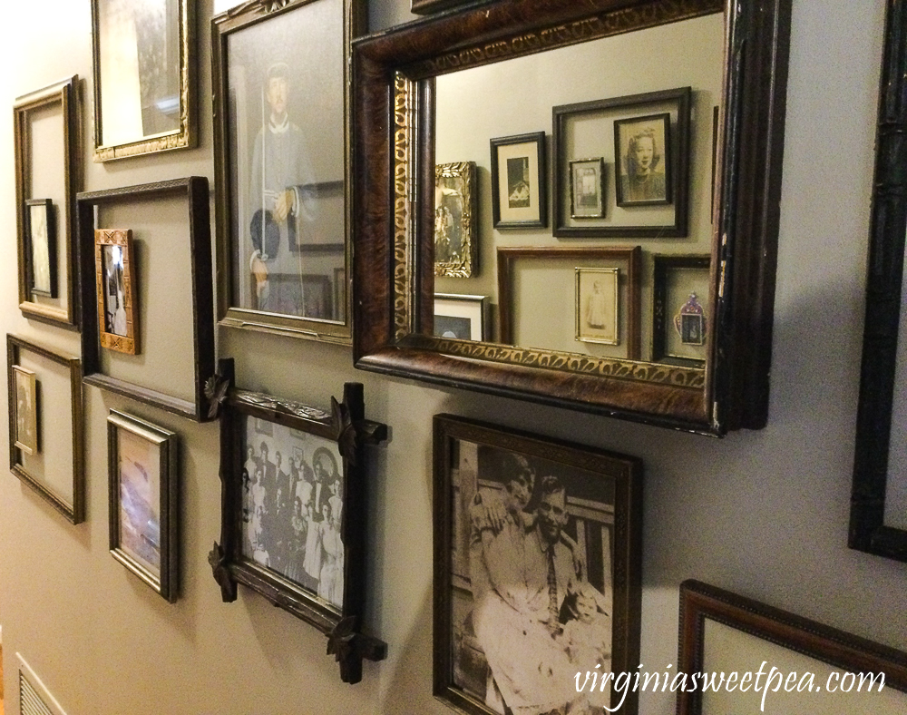 Collection of vintage frames lining the walls of a hallway