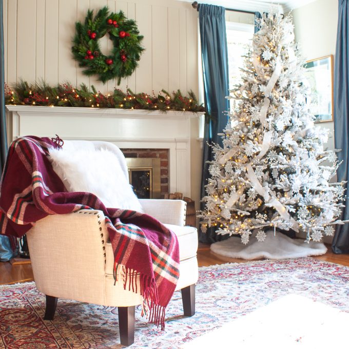 Living room decorated for Christmas with a flocked Christmas tree