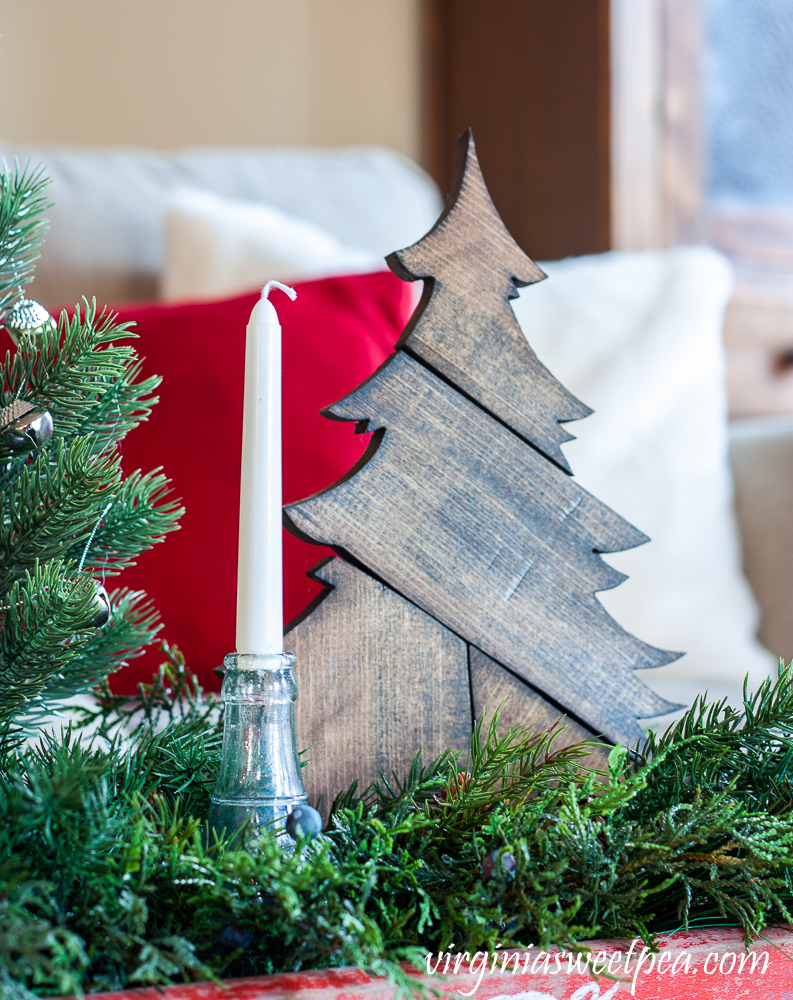 Handmade wood Christmas tree surrounded by greenery in a vintage Coca-Cola crate