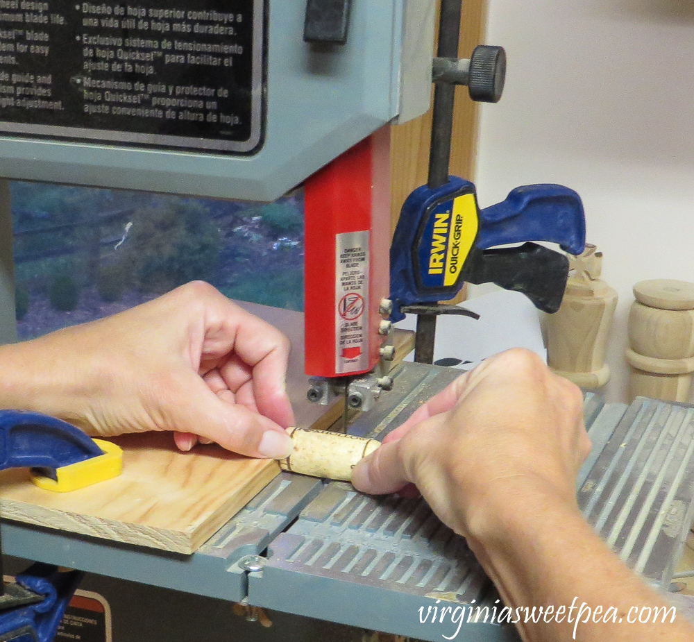 Cutting a wine cork in half using a bandsaw.