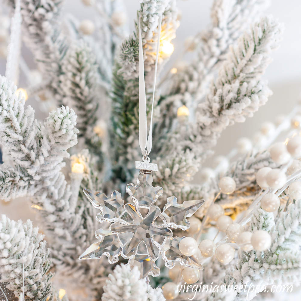 2020 Swarovski snowflake ornament on a tree decorated with a snowflake theme