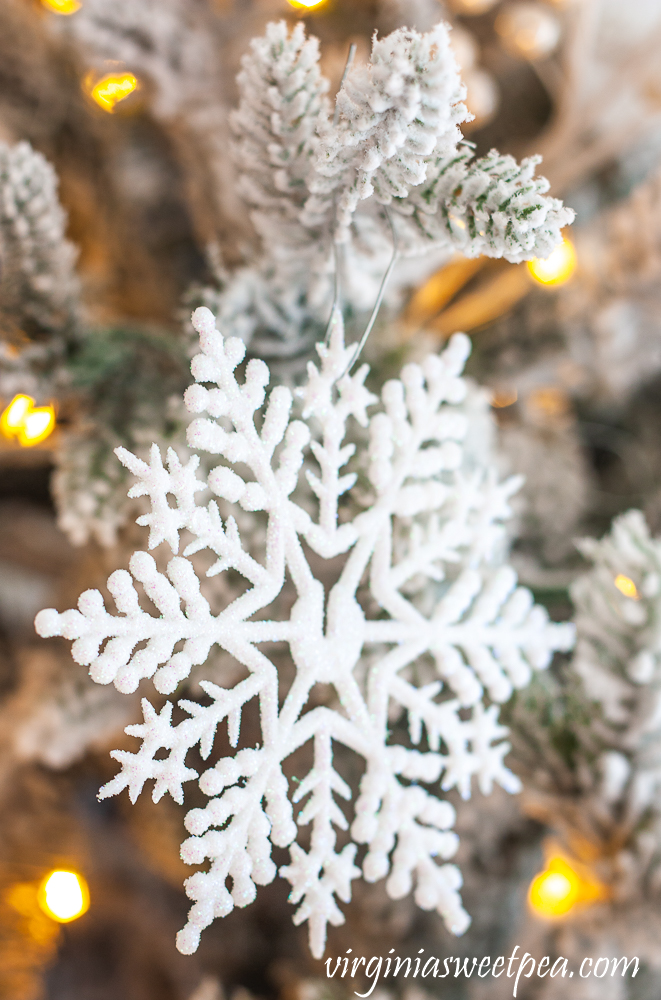 White snowflake on a flocked Christmas Tree