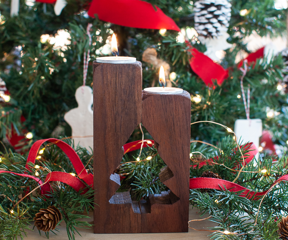 Candle holder made from upcycled furniture legs with tree cut out holding two tea lights