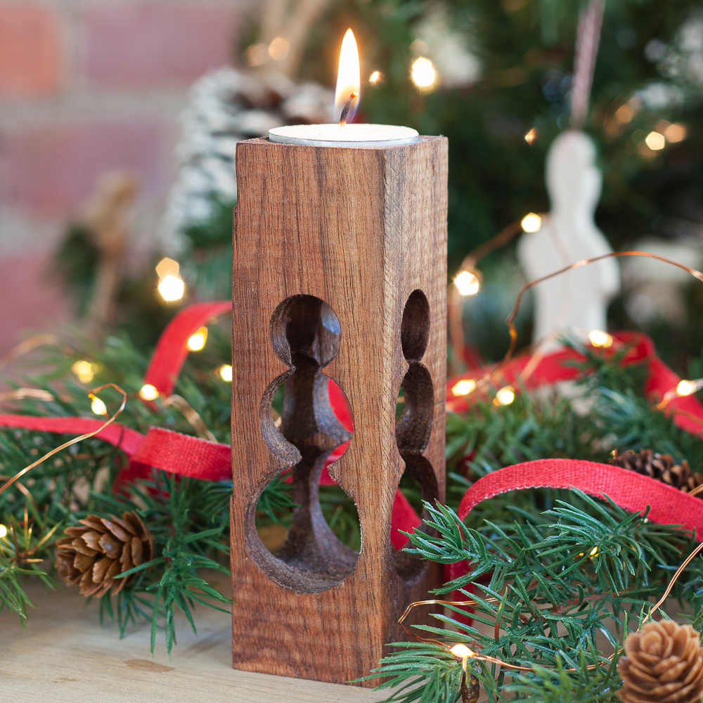 DIY wooden candle holder with a snowman cut into the wood