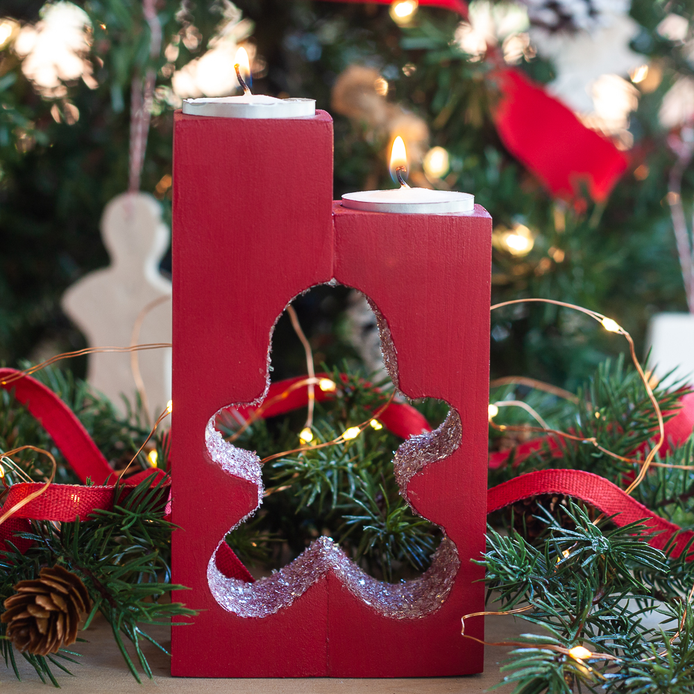 DIY wooden candle holder with a gingerbread man cut into the wood