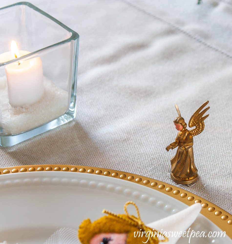 Vintage tiny musical angel Christmas ornament used on a Christmas table