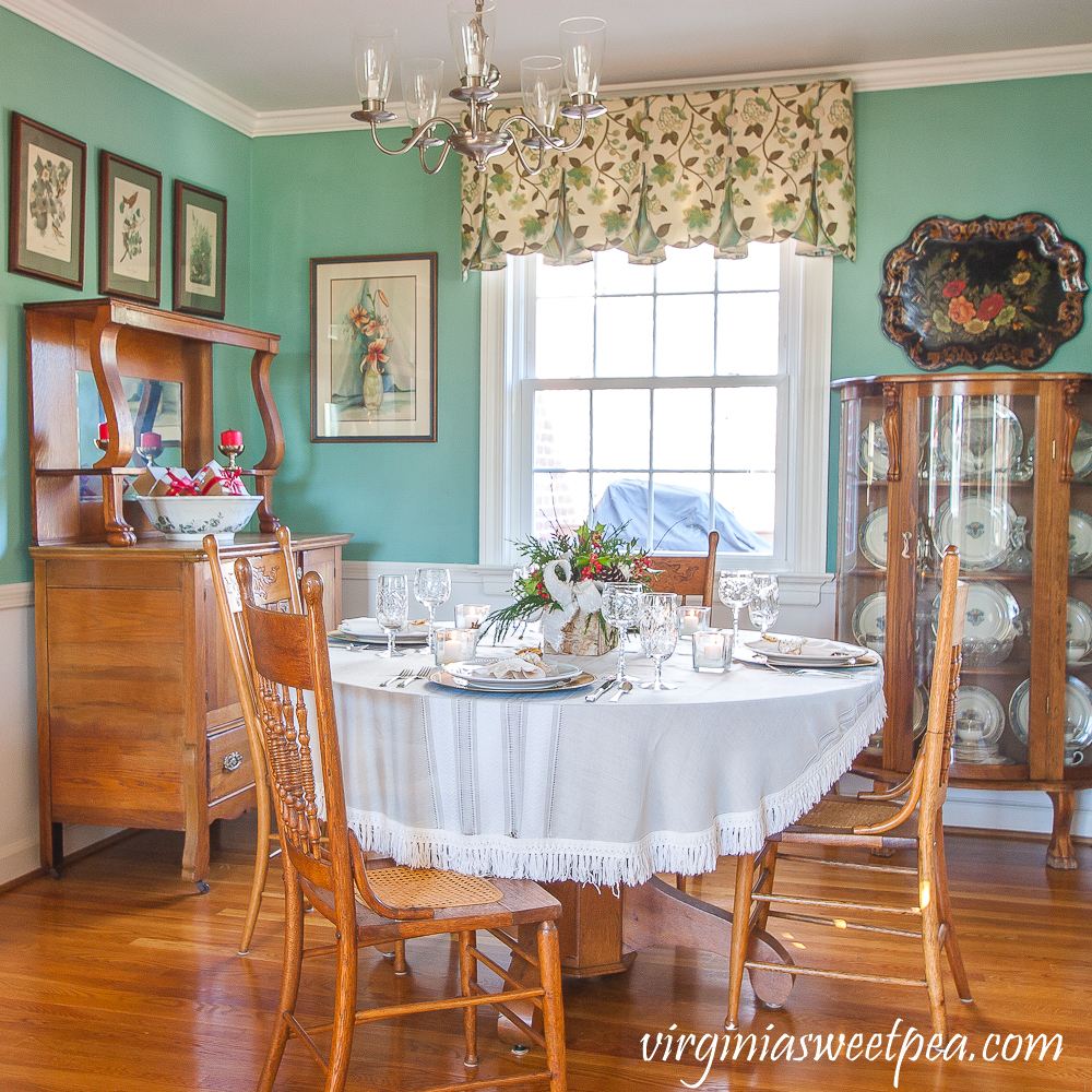 Dining room decorated for Christmas with a Christmas tablescape