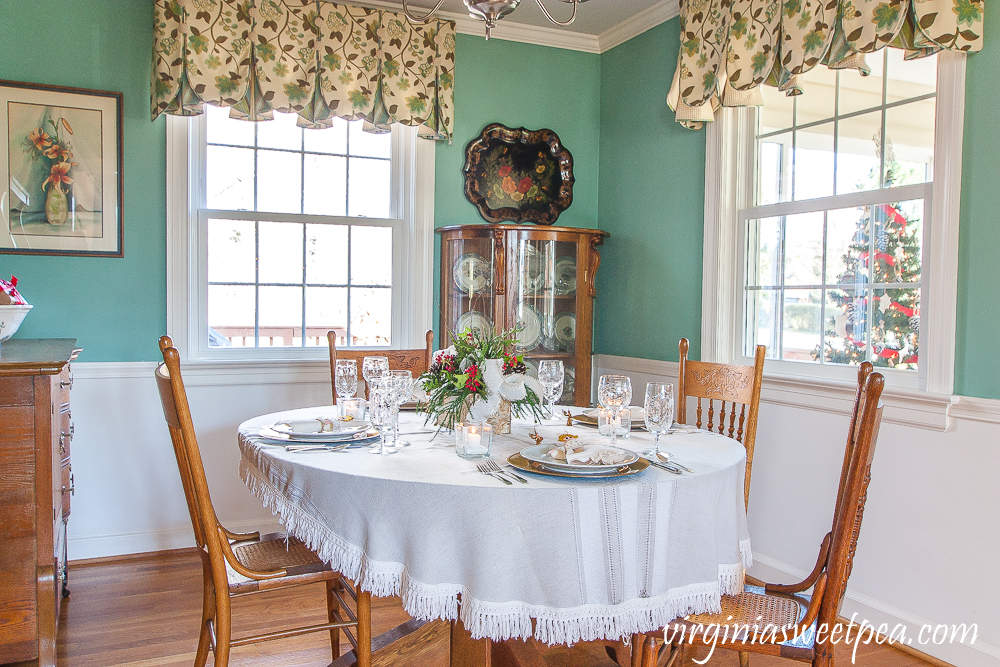 Dining room decorated for Christmas with a Christmas tablescape