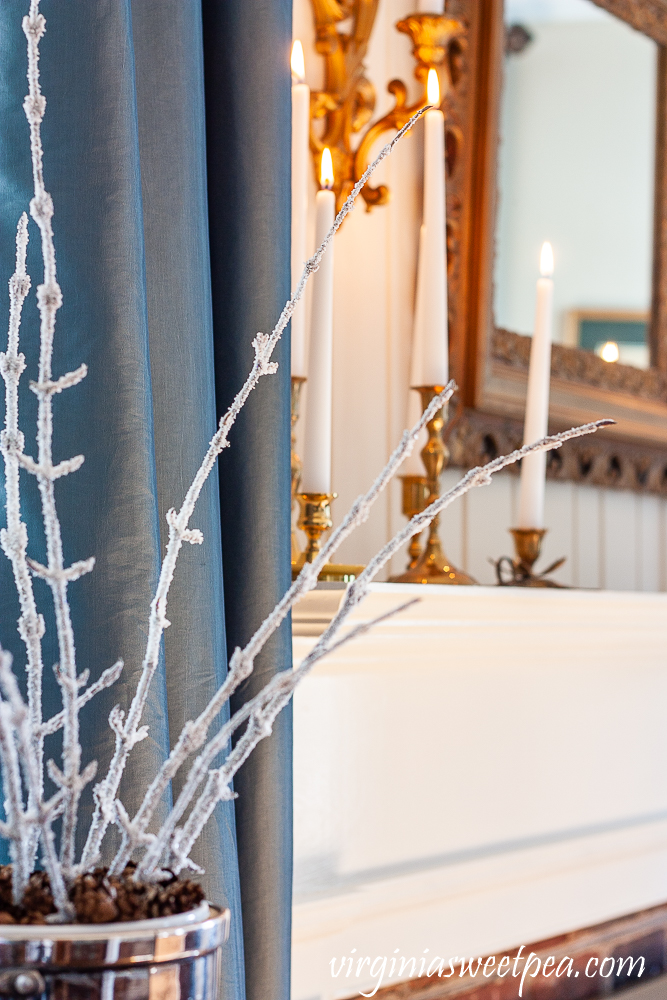 Winter decorating with candles and frosted branches.