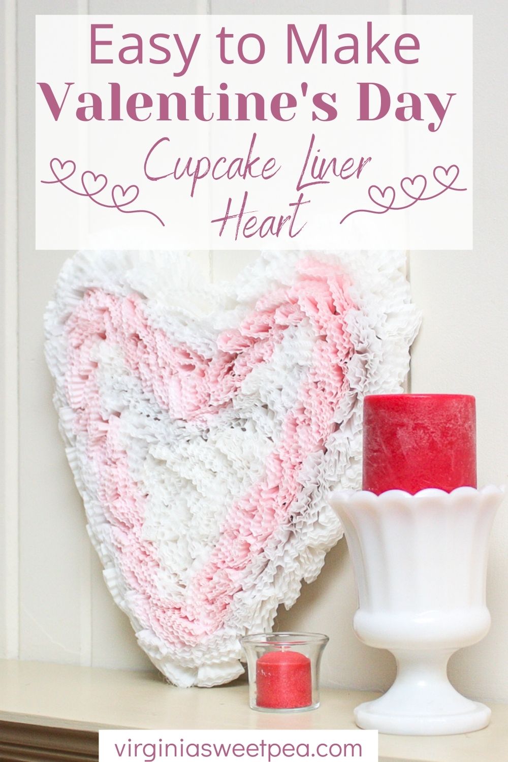 Heart cut from cardboard and decorated with pink and white cupcake liners