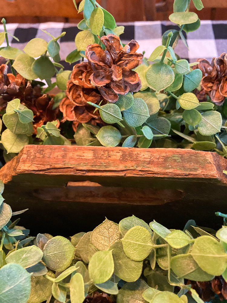 Vintage toolbox decorated with Eucalyptus and pinecones.